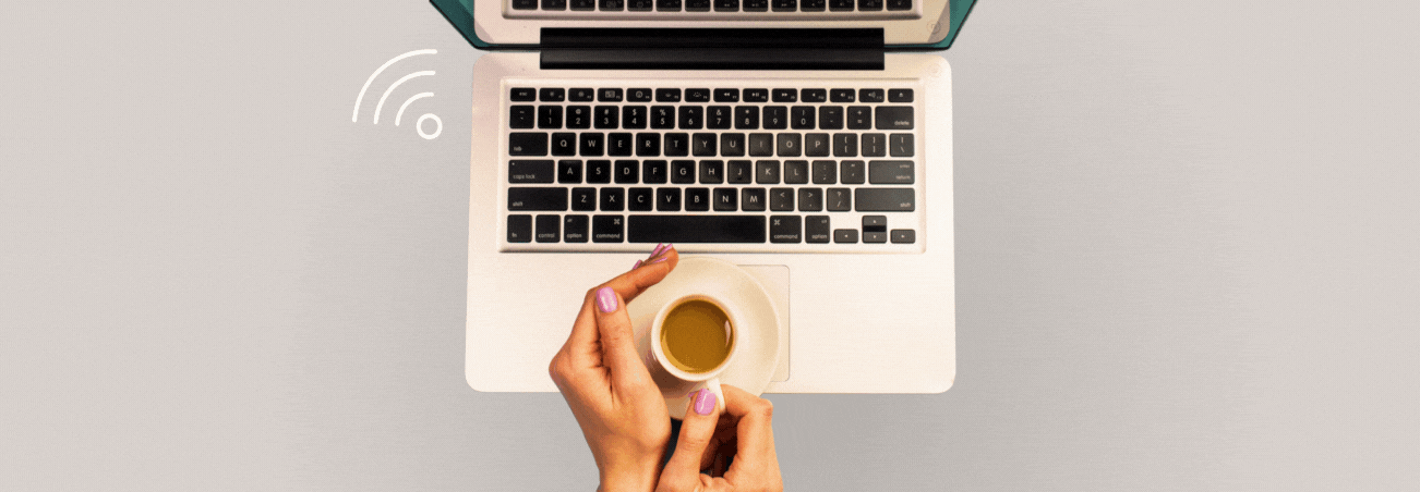 a laptop with two hands coming from off-screen and holding coffee