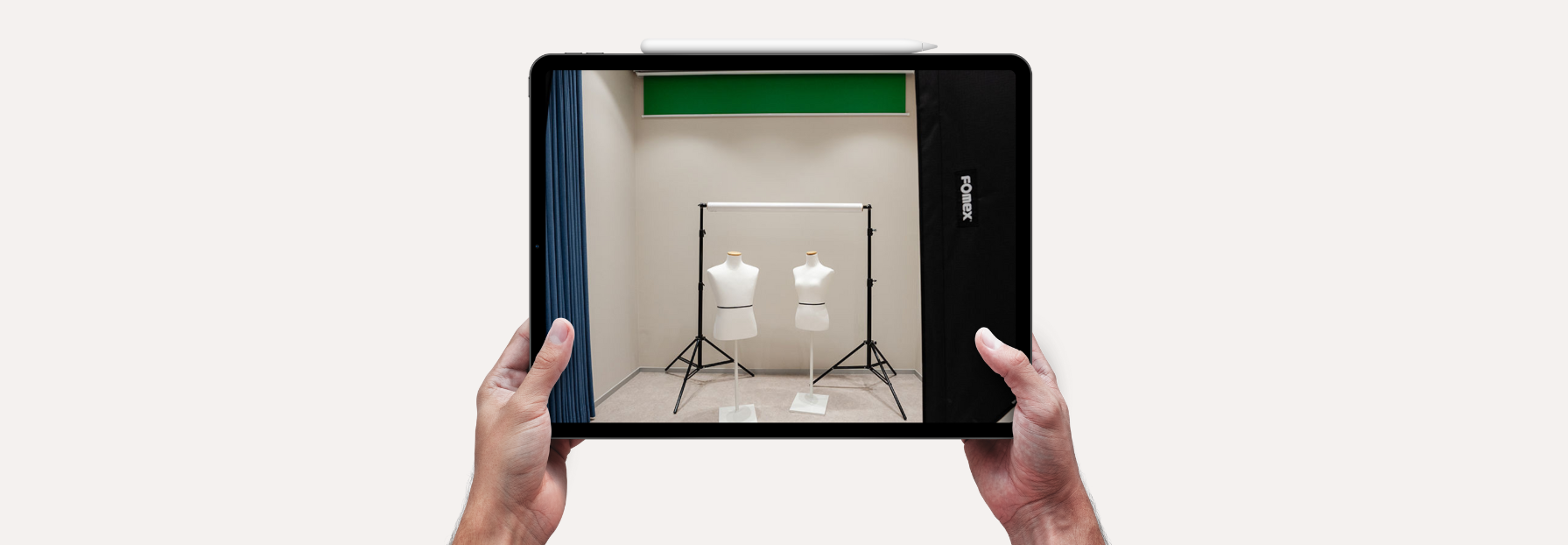 person holding a tablet with a photo o a studio
