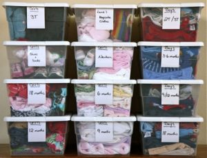 Clothes organized in clear storage bins