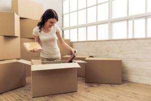 woman packing her belongings into a moving box