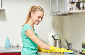 a woman cleaning her kitchen